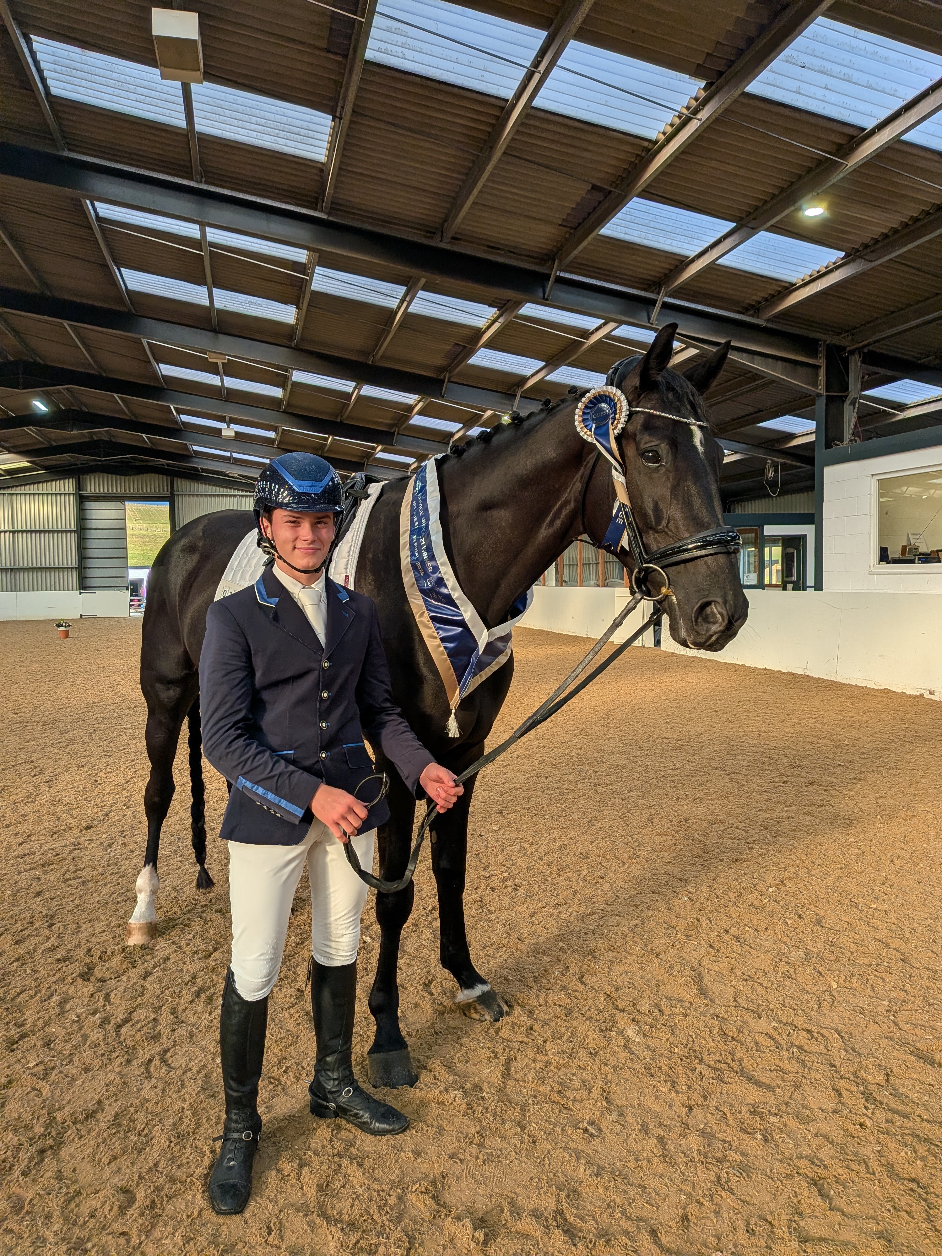 Lucas with dressage horse and ribbon